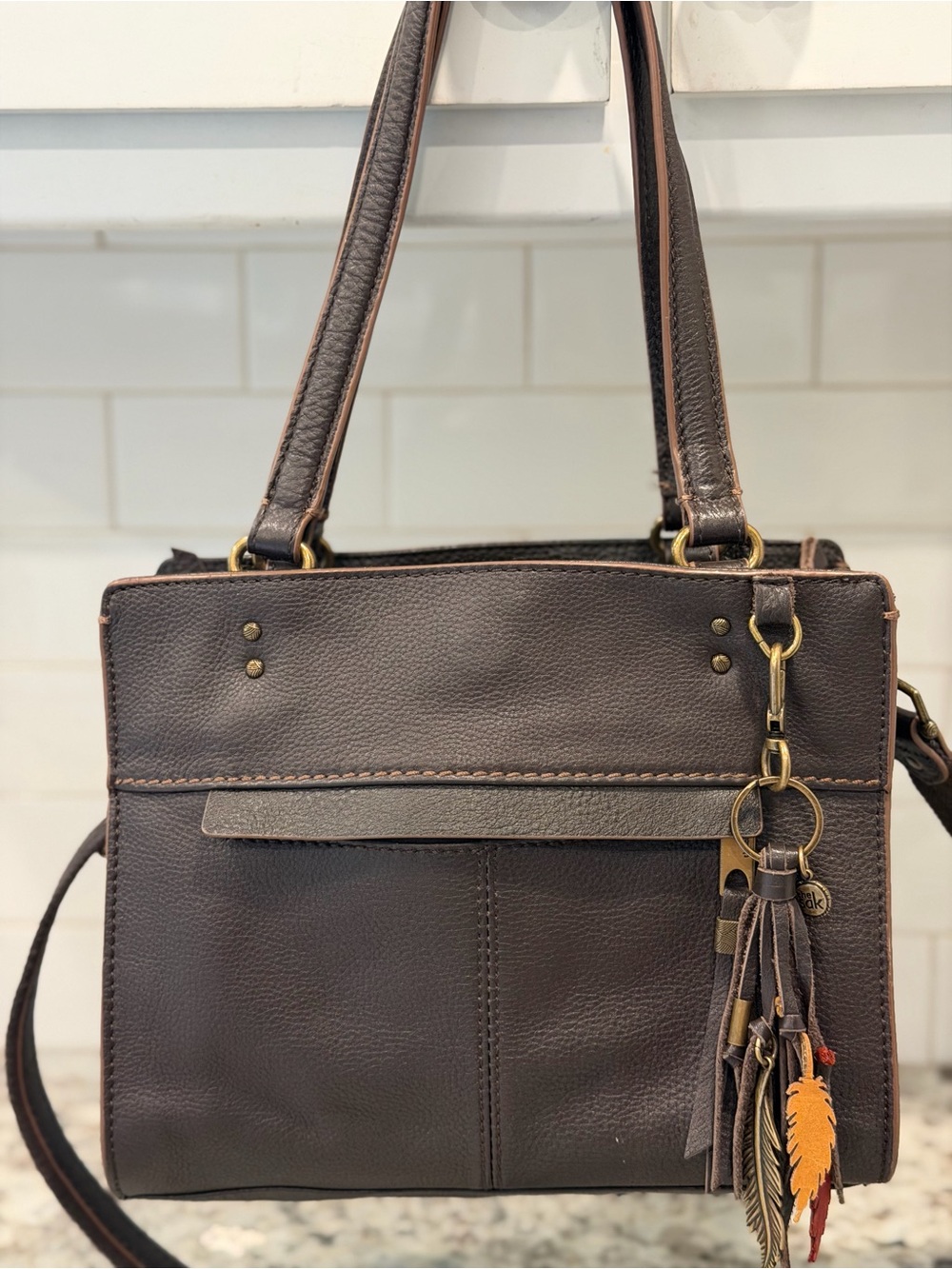 The Sak Dark Brown Leather Crossbody with Tassel Charm